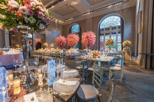 free-photo-of-reception-venue-decorated-with-colorful-trees-and-flowers